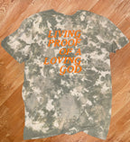 Camo Styled Bleached Tshirt with Hunter orange lettering saying “Living Proof Of A Loving God”