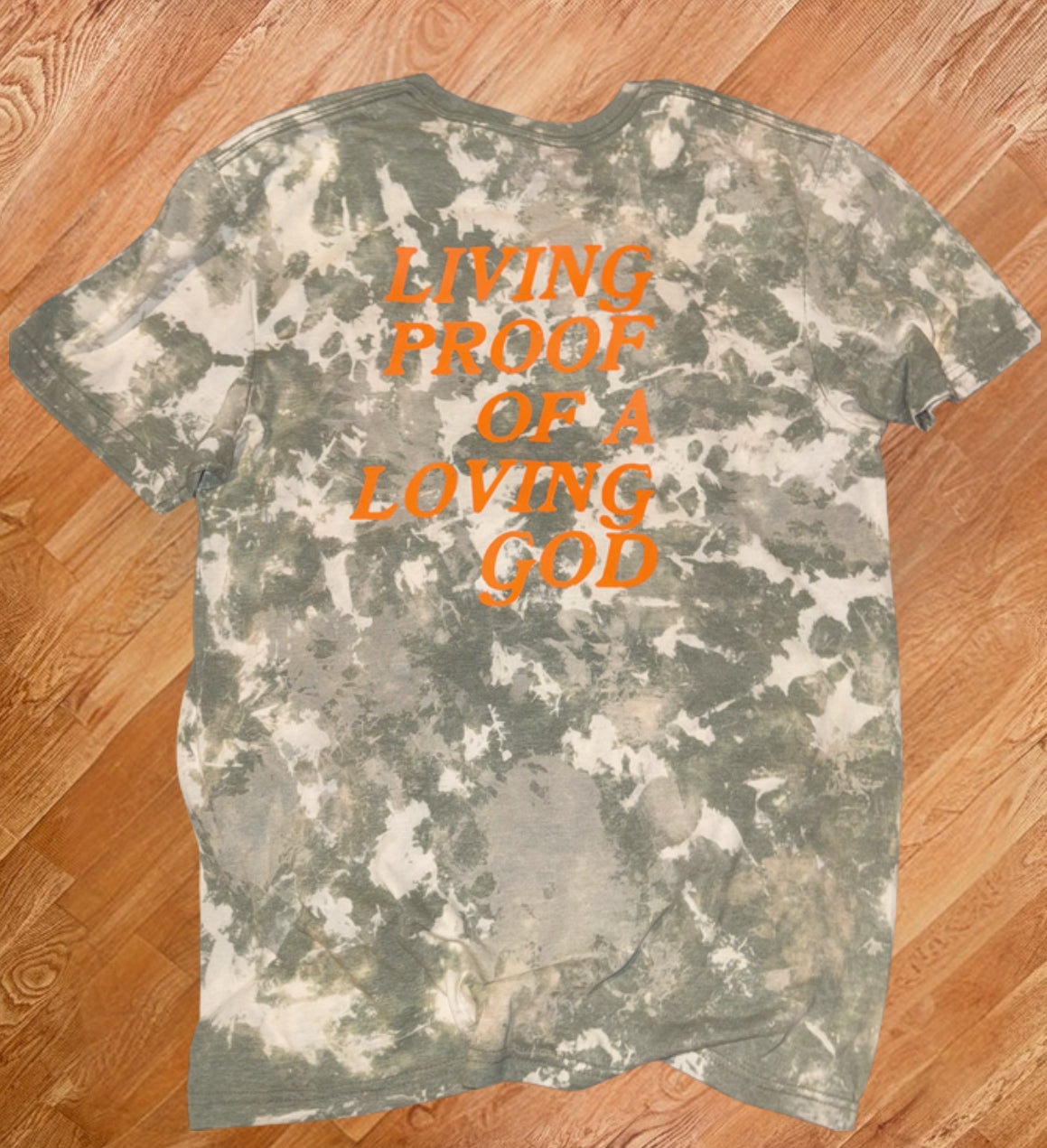 Camo Styled Bleached Tshirt with Hunter orange lettering saying “Living Proof Of A Loving God”