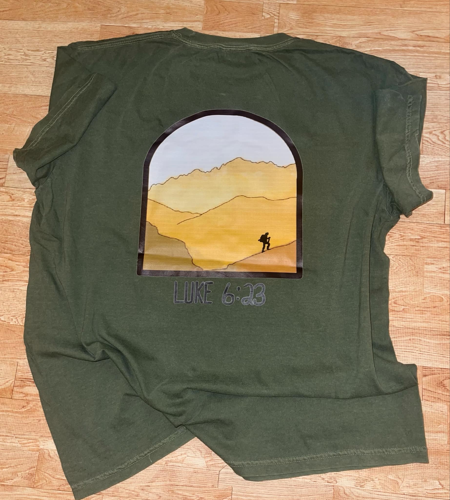 Man Hiking up mountains in an arch design giving visual to taking that leap of faith